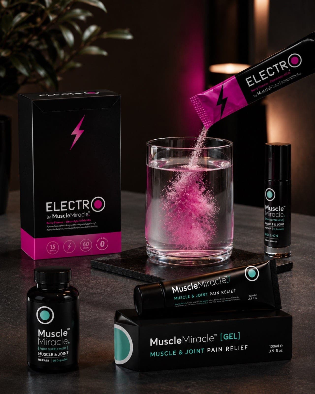 Muscle Miracle Electrolytes Berry sachet dissolving into a glass of water, with the gel, roll-on and capsules alongside