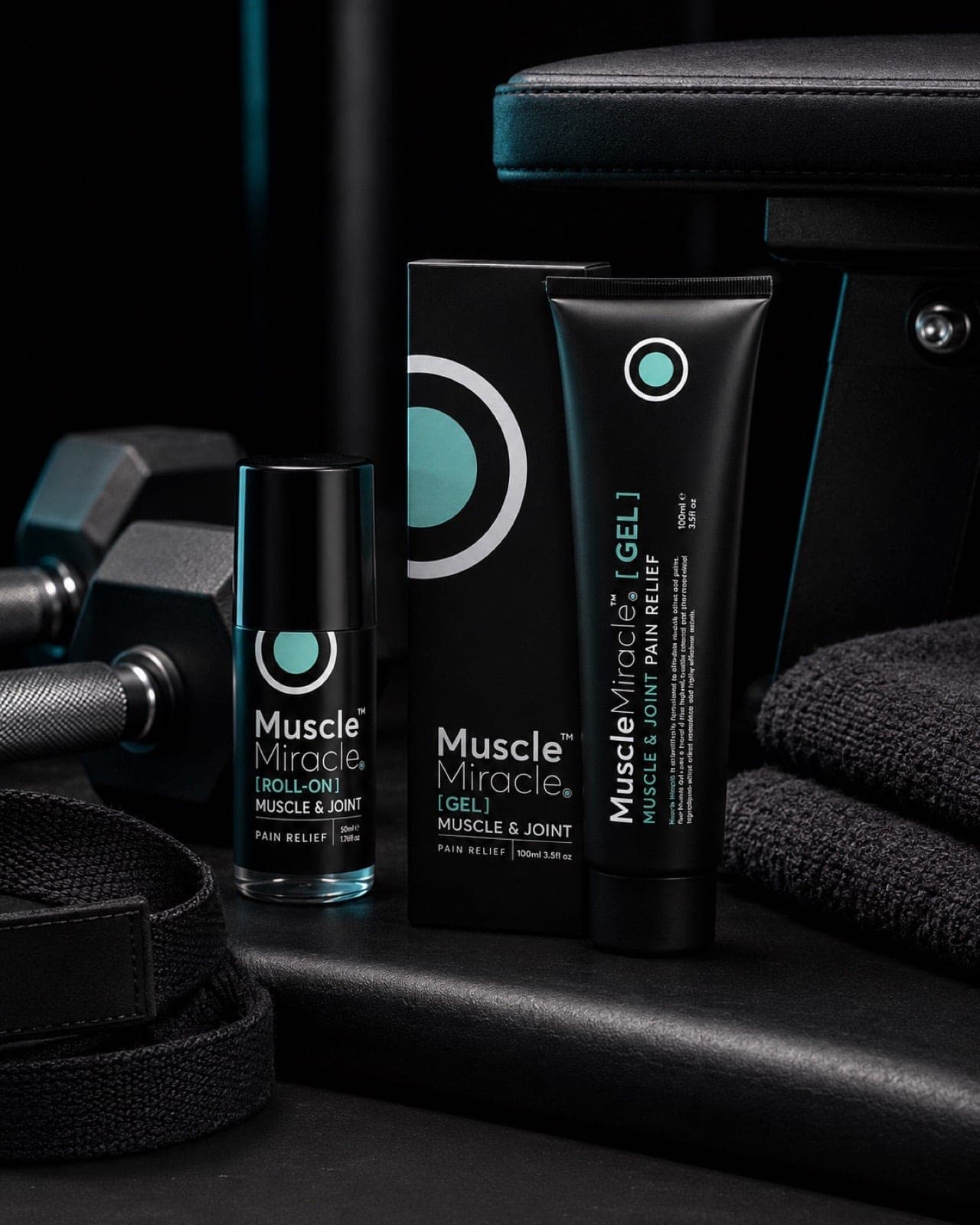 Muscle Miracle gel and roll-on on a dark bench beside a dumbbell and towel, lit in teal